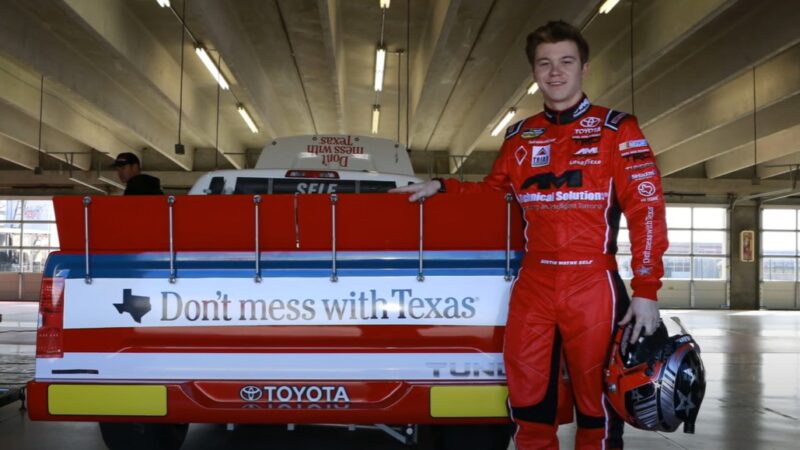 Driver Austin Wayne stands with his car branded with the Don't mess with Texas logo