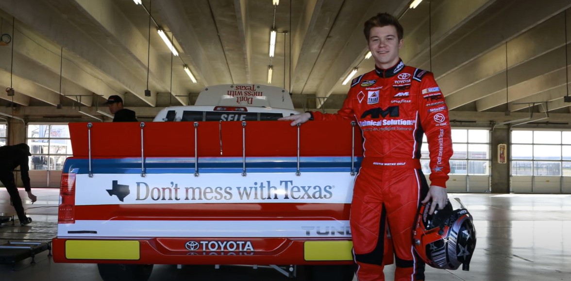 Driver Austin Wayne stands with his car branded with the Don't mess with Texas logo