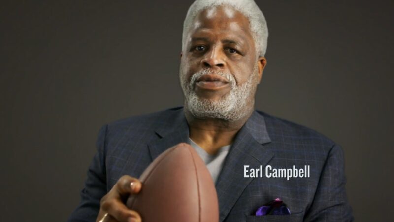 Houston Oilers running back Earl Campbell holding a football.