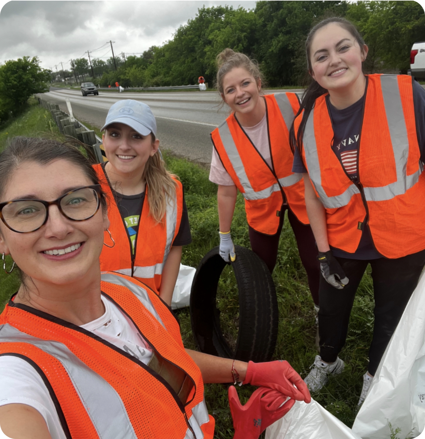 "GDC Marketing & Ideation" volunteers are taking a selfie while they clean a Texas highway.